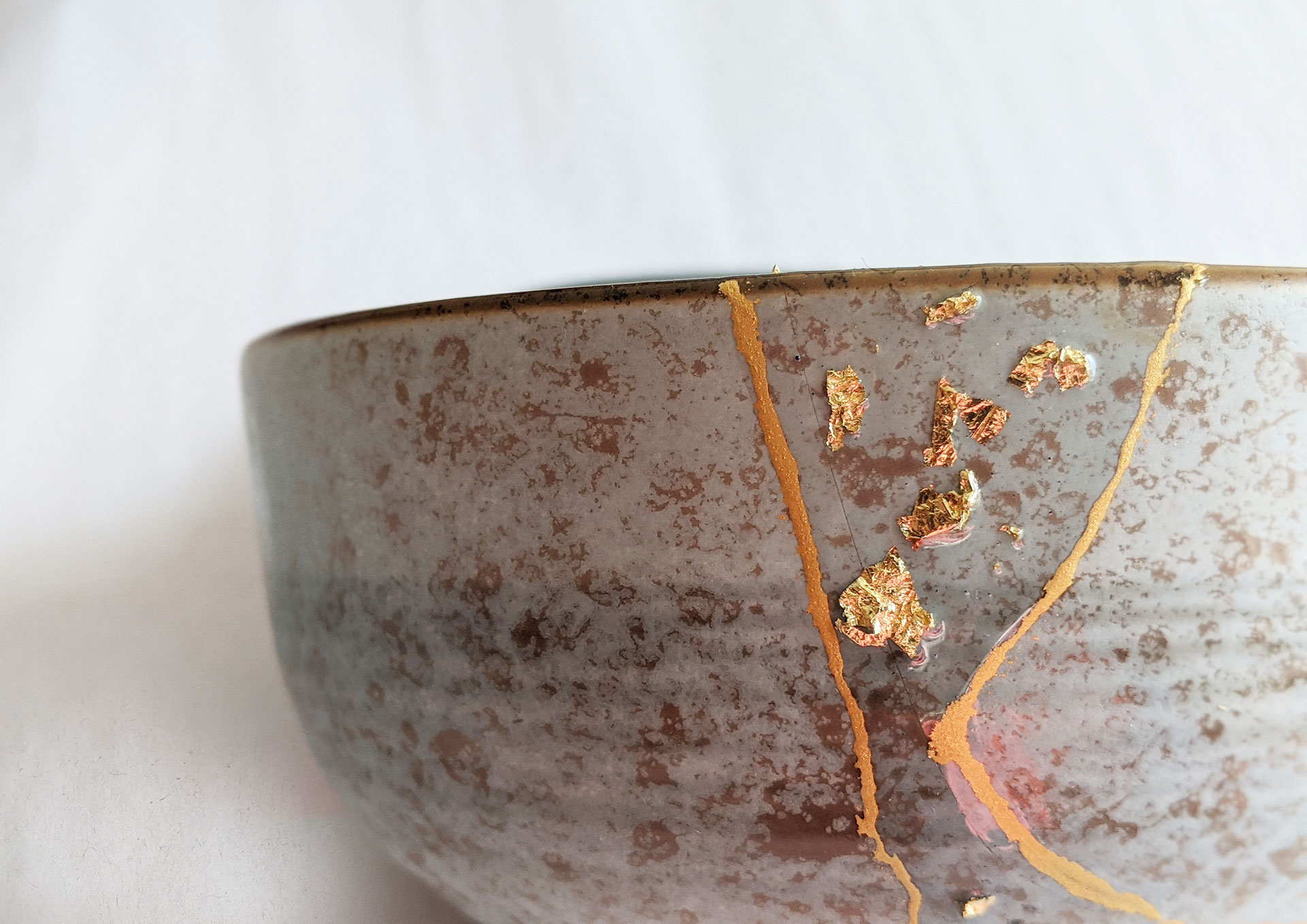 Kintsugi Repair: Gold color plus resin embedded with gold flakes by Fan Stanbrough