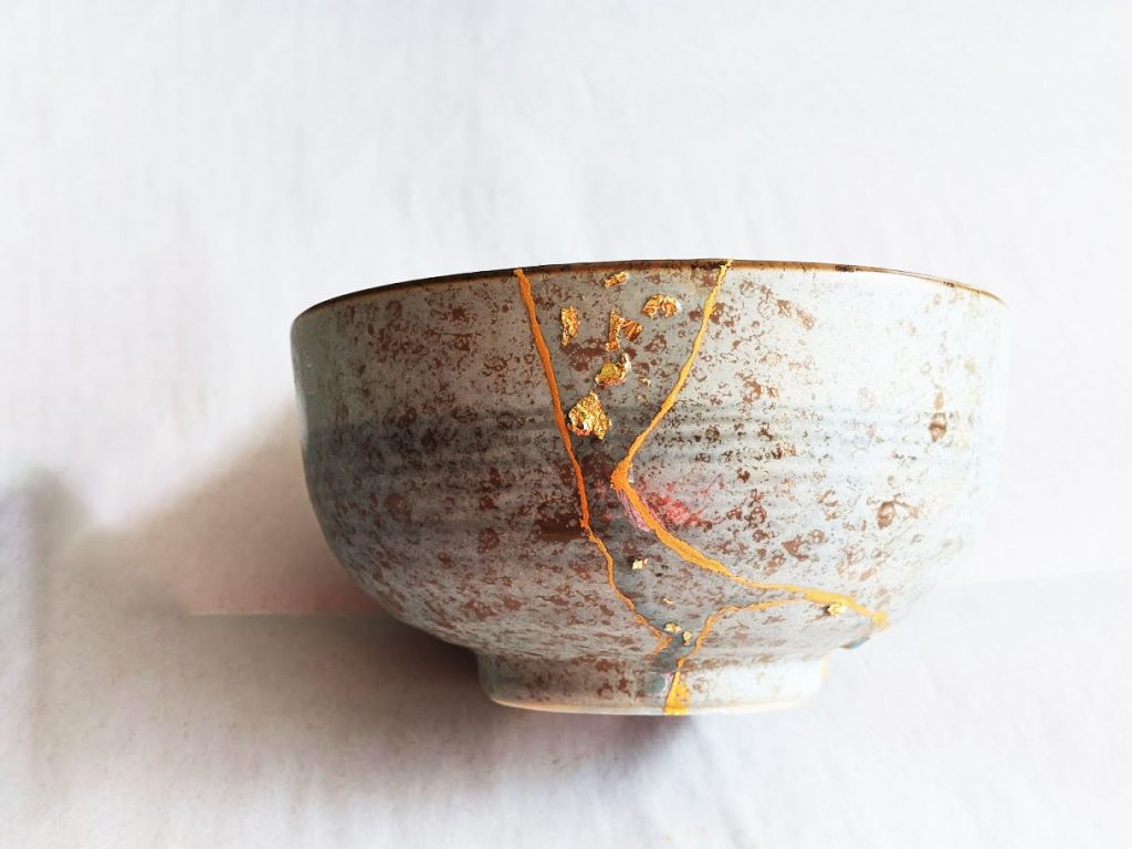 Kintsugi Repair: Gold color plus resin embedded with gold flakes by Fan Stanbrough