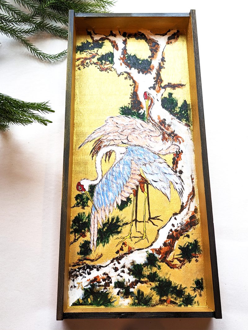 Cranes on Branch of Snow-covered Pine on a Wooden Box