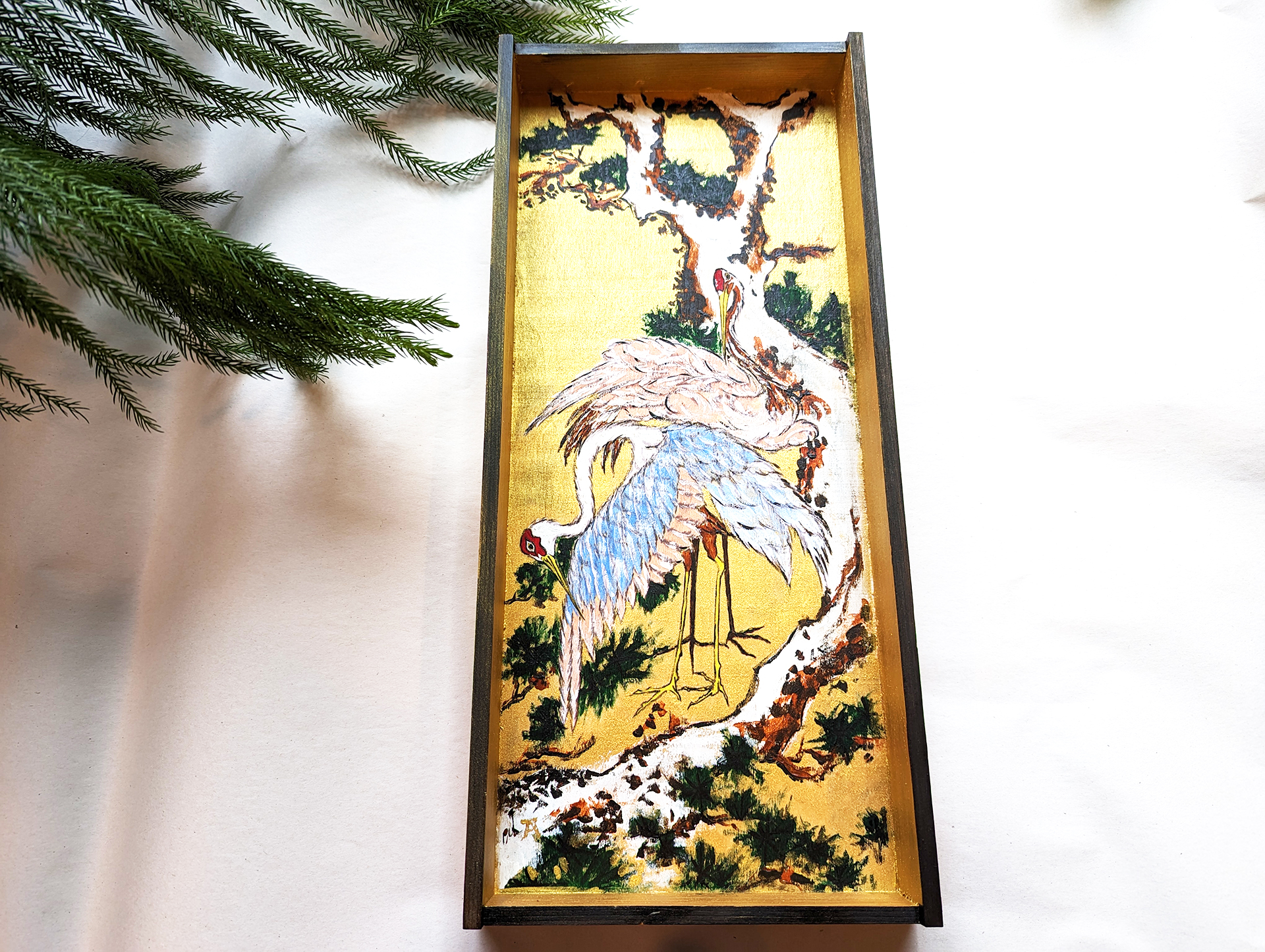 Cranes on Branch of Snow-covered Pine on a Wooden Box 